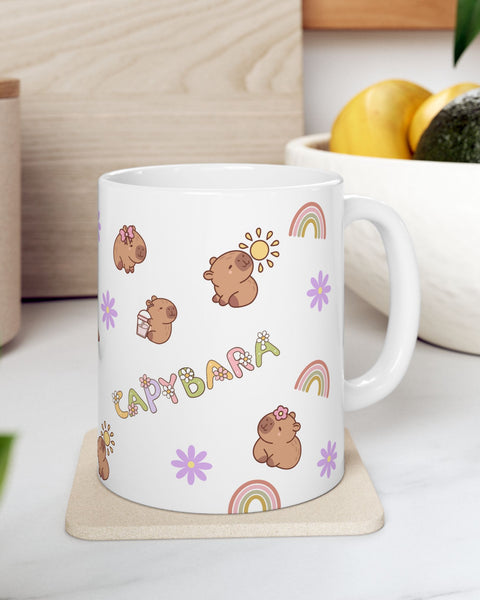 White mug with capybara illustrations on a wooden coaster