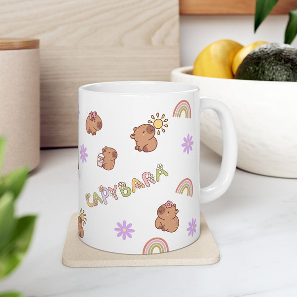 White mug with capybara illustrations on a wooden coaster