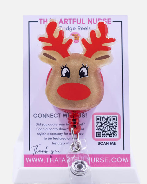 Retractable badge reel shaped like a reindeer on a card with branding information.
