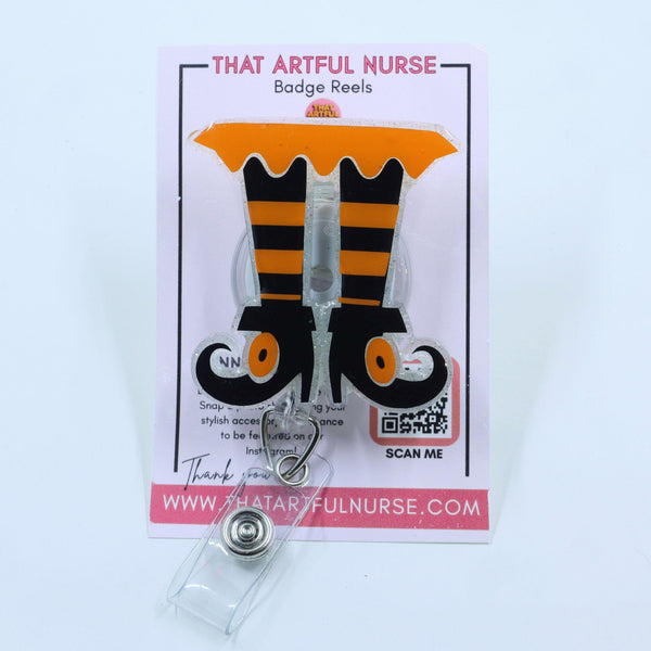 Spooky Legs badge reel featuring orange and black striped witch legs with curled shoes
