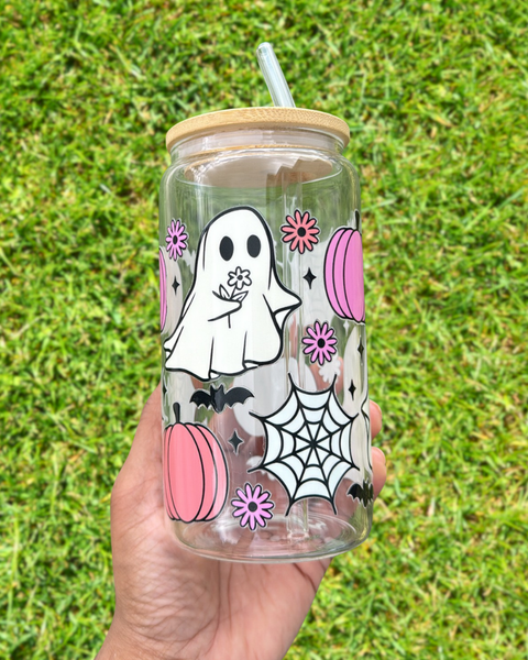 Clear glass can tumbler with elegant Halloween-themed designs featuring ghosts holding daisies, and surrounded by cute bat and pumpkin graphics.