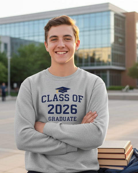 Young man wearing a 'Class of 2026 Graduate' sweatshirt on a college campus.