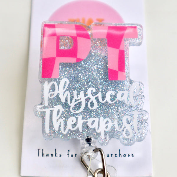 A physical therapist badge reel with two shades of pink colors featuring a checkered design, attached to an ID clip.