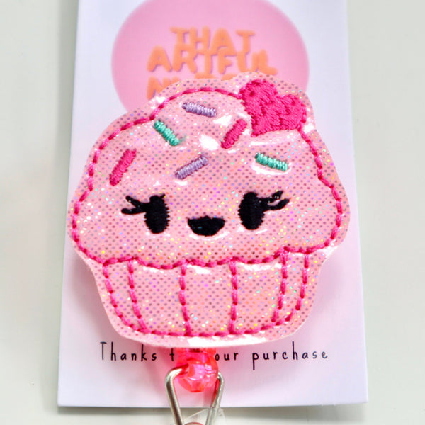 A badge reel featuring a colorful cupcake design, perfect for adding a fun touch to your ID display.